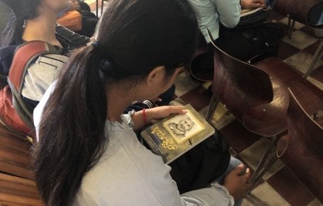 A woman holds a copy of Sovicheth Meta's Khmer translation of Hédi Fried's book "Questions I Am Asked About the Holocaust" in Phnom Penh on July 19, 2019. (Matt Surrusco)