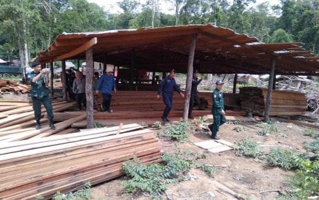Members of an anti-forestry crimes task force inspect illegal timber in Mondulkiri province's Koh Nhek district on July 16, 2019. (National Military Police)