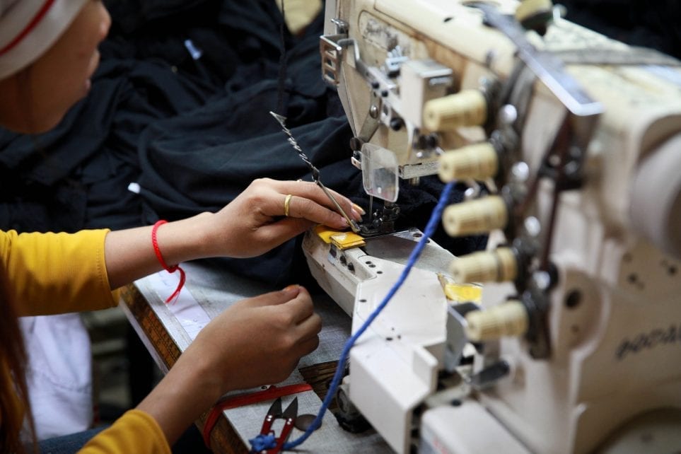 A garment worker uses a sewing machine in a factory in Cambodia on December 9, 2014 (ILO)