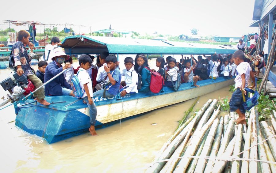 Children leave the floating Kbal Taol Primary School in Battambang province’s Koh Chivaing commune by boat.