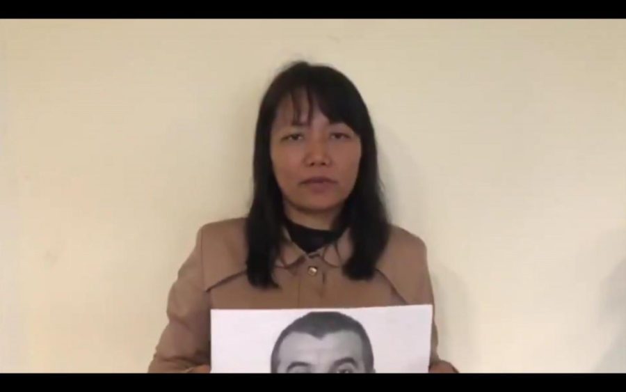 Grace Karaca holds up a photo of her arrested husband, Osman Karaca, in a video she posted to Twitter on October 18, 2019.
