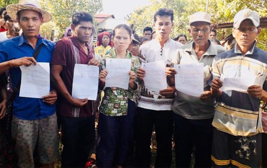 Six representatives of Koh Kong villagers engaged in a land dispute with Heng Huy Agriculture Group hold up their court summonses on November 27, 2019. (Supplied)