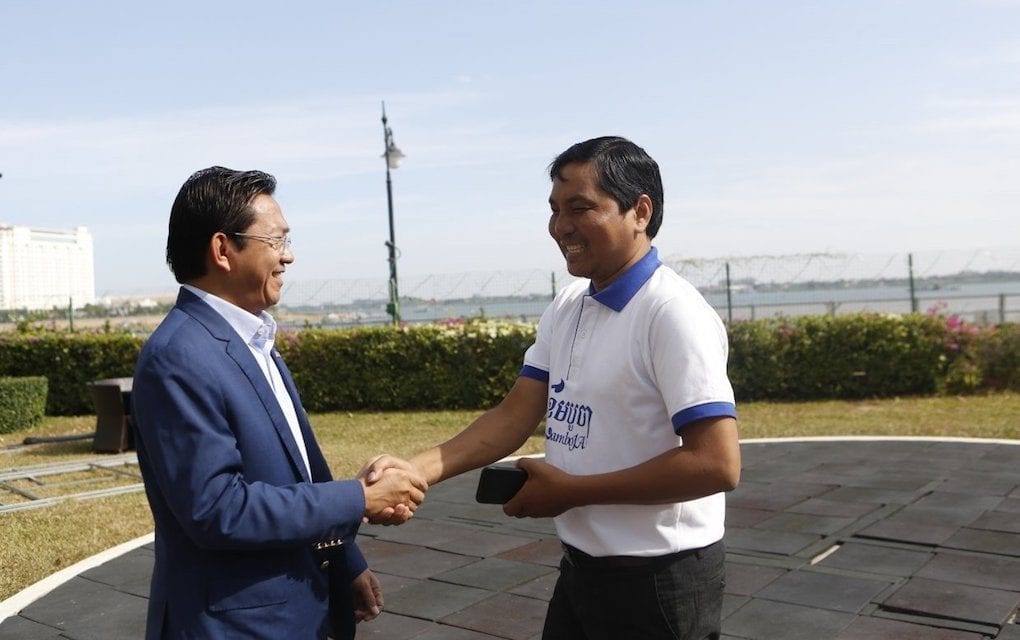 Huy Vannak, Interior Ministry official (left), shakes hands with May Titthara, CamboJA’s executive director, at the CamboJA launch event on December 13, 2019 in Phnom Penh (CamboJA)