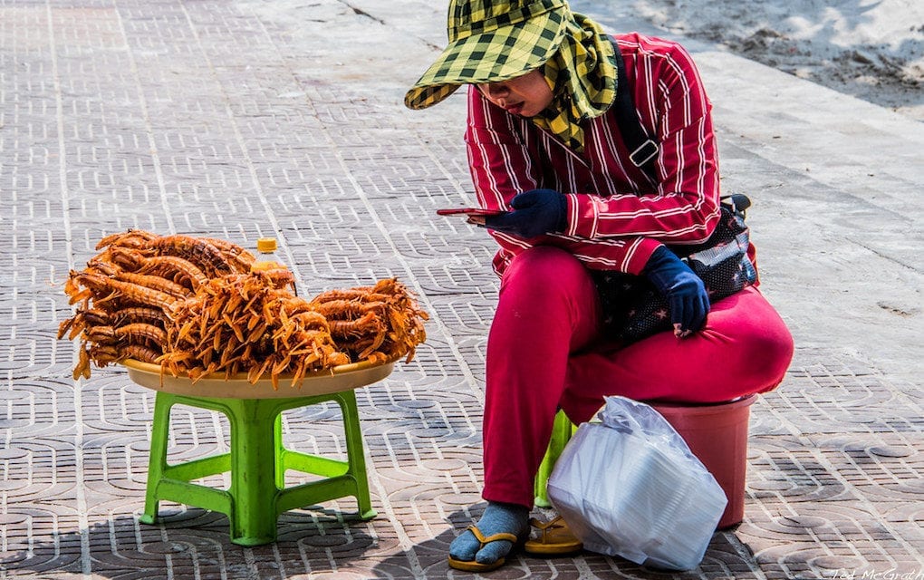 A woman sells seafood at Sihanoukville's O’Chheuteal beach in 2009 (Creative Commons)