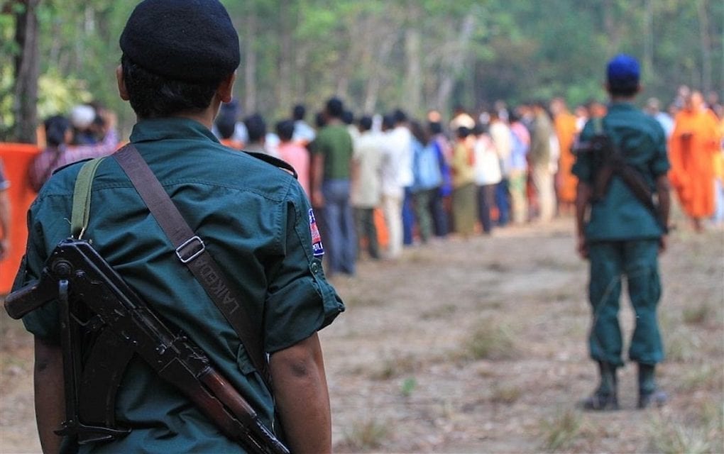 Armed police monitor participants of a tree blessing ceremony in Prey Lang protected forest in 2019 (Licadho)