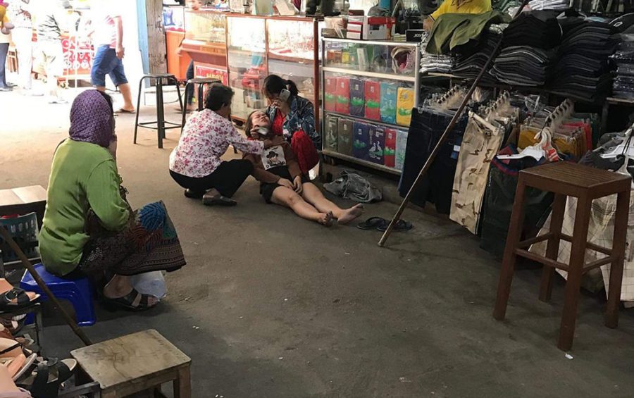 A woman faints in a market in Kampong Cham province, in this photograph posted to the Facebook page LY SokMal on March 8, 2020.