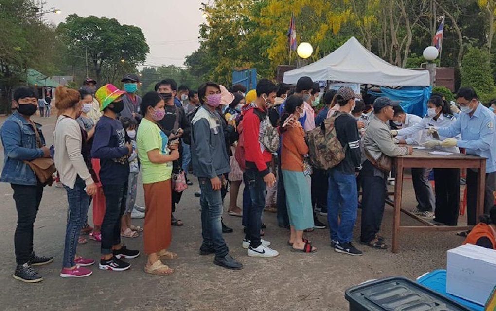 Authorities at the O'Smach International Border Checkpoint check temperatures of Cambodian workers returning from Thailand, in a photograph posted to the Immigration Department's Facebook page on March 23, 2020.