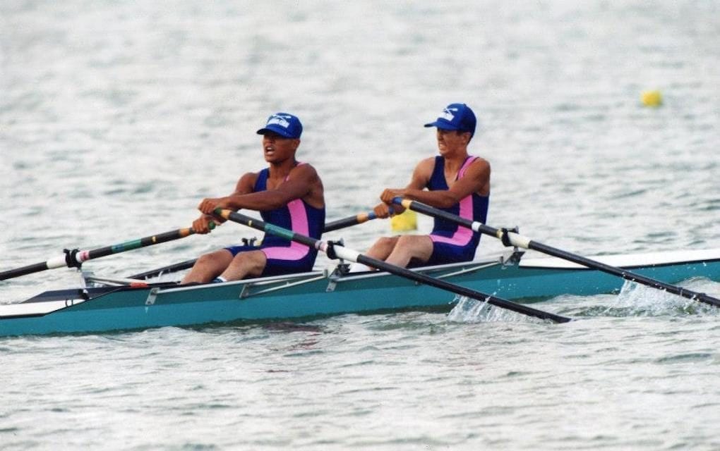 Kenji Kuraki (left) and his teammate pull oars in sync during a high school rowing competition. (Courtesy of Kenji Kuraki)