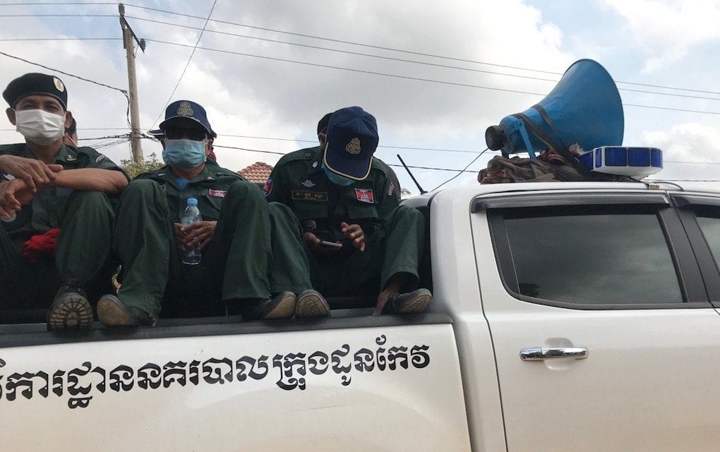 Authorities sit in the bed of a pickup truck in Takeo province in late March 2020 (Ouch Sony/VOD)