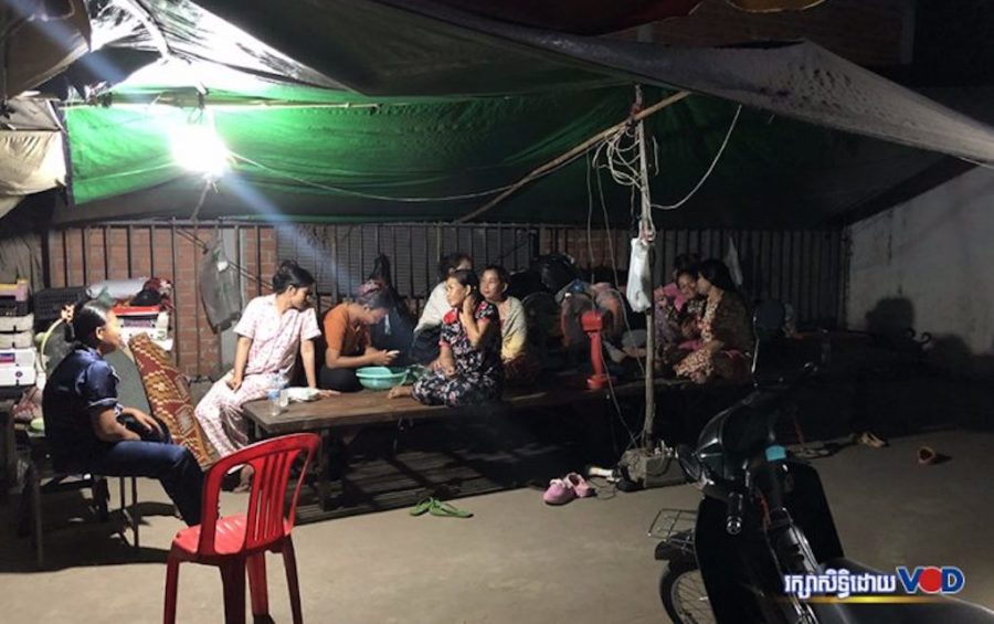 Former Dignity Knitter workers spend their evenings under a tent in front of the closed Takhmao City factory on May 1, 2020. (Hun Sirivadh/VOD)