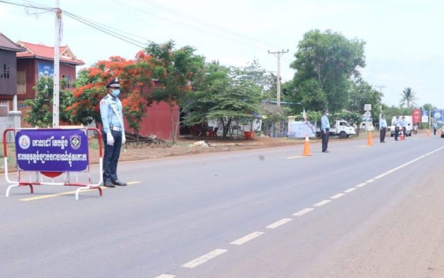 Traffic police stand along National Road 6 in Kampong Thom province on May 13, 2020. (Kampong Thom Provincial Police Headquarters)