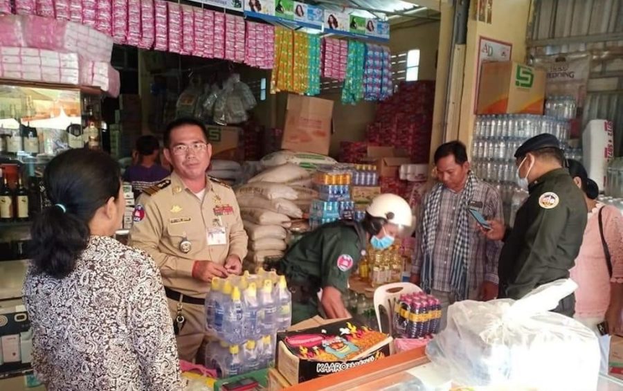 Police collect bottles of a wine product linked to multiple deaths in Banteay Meanchey province on June 11, 2020. (Banteay Meanchey Provincial Police)