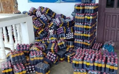Stacked cases of a wine product linked to multiple deaths in Banteay Meanchey province on June 11, 2020. (Banteay Meanchey Provincial Police)
