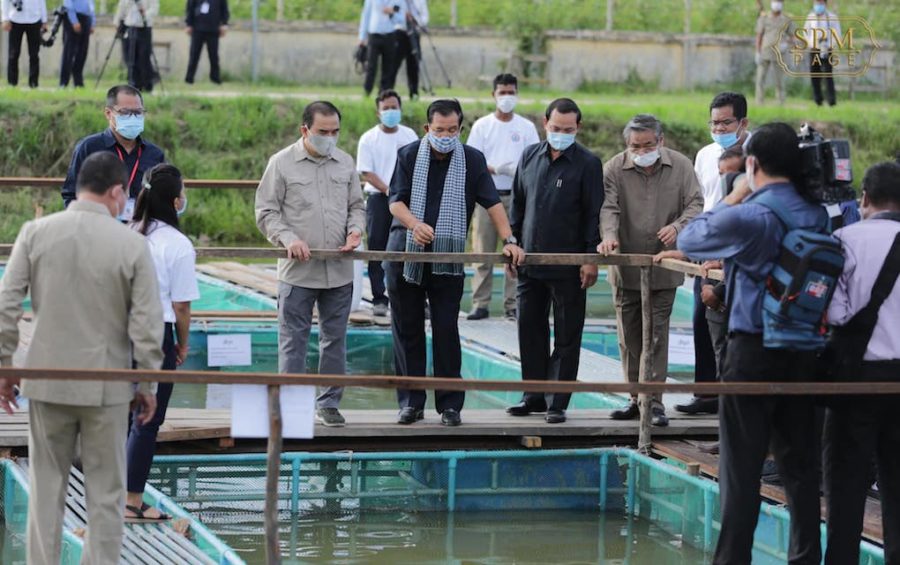 Prime Minister Hun Sen (center) observes fish and frog ponds at the Freshwater Aquaculture Research and Development Center in Prey Veng province in a photo posted to Hun Sen’s Facebook page on July 14, 2020.