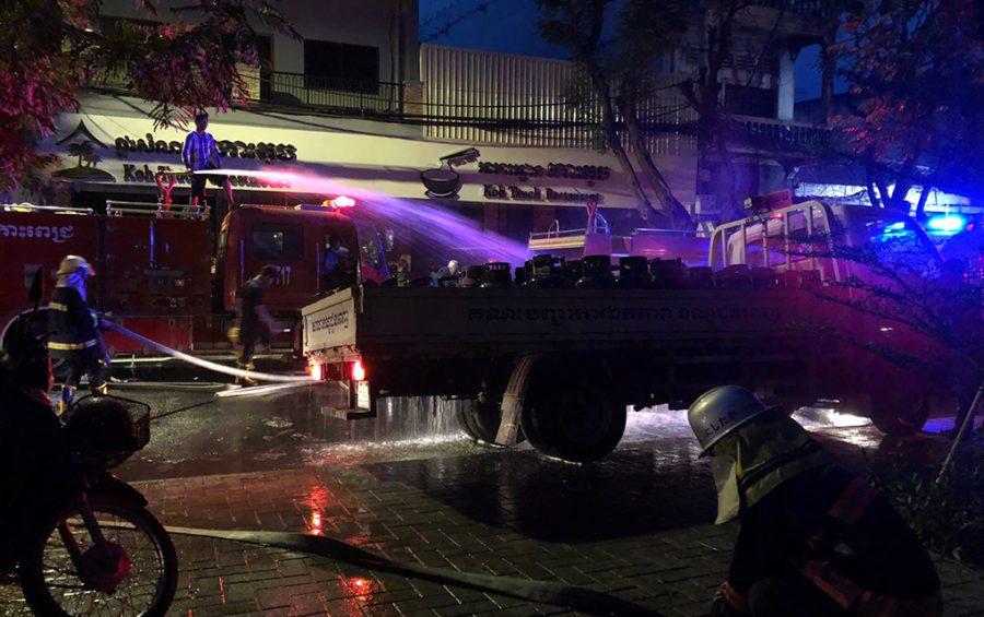 Firefighters spray down gas canisters with water at the site of an explosion in Phnom Penh on July 18, 2020. (Matt Surrusco/VOD)