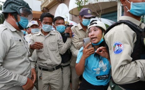 Activist Chhoeun Daravy is surrounded by authorities during a protest outside the Phnom Penh Municipal Court near City Mall on the morning of August 13, 2020 (Licadho)