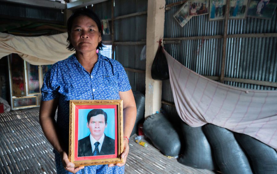 Kat Chang poses for a portrait in her home with a picture of her late husband Toun Sarith, who died of rabies. (Andy Ball/VOD)