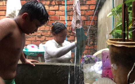 A family collects rainwater to save money on water expenses, in Phnom Penh’s Chbar Ampov district on June 12, 2020. (Hun Sirivadh/VOD)