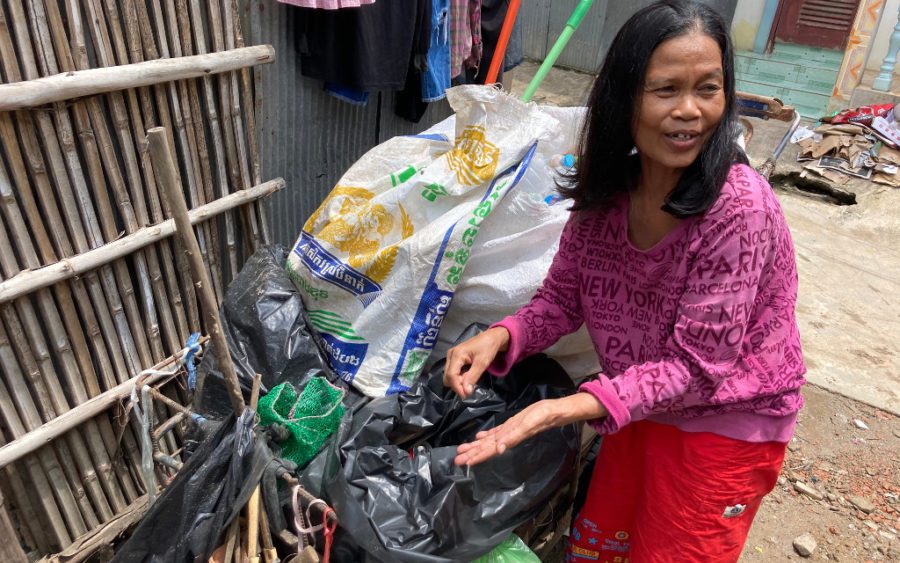 Keo Chen says she mostly collects plastic materials and bottles when she picks through waste with her sister, and unemployed porter, Keo Srun in Banteay Meanchey's Poipet city. (Ananth Baliga/VOD)
