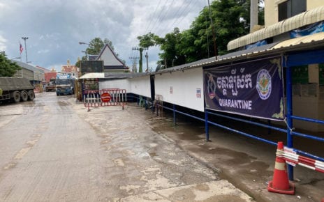 Goods trucks pass a quarantine center to cross the Thai border into Cambodia at Poipet. (Ananth Baliga/VOD)