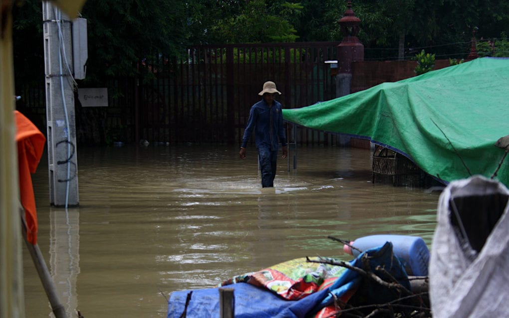 A man walks through floodwaters in Phnom Penh’s Dangkao district on October 12, 2020. (Michael Dickison/VOD)