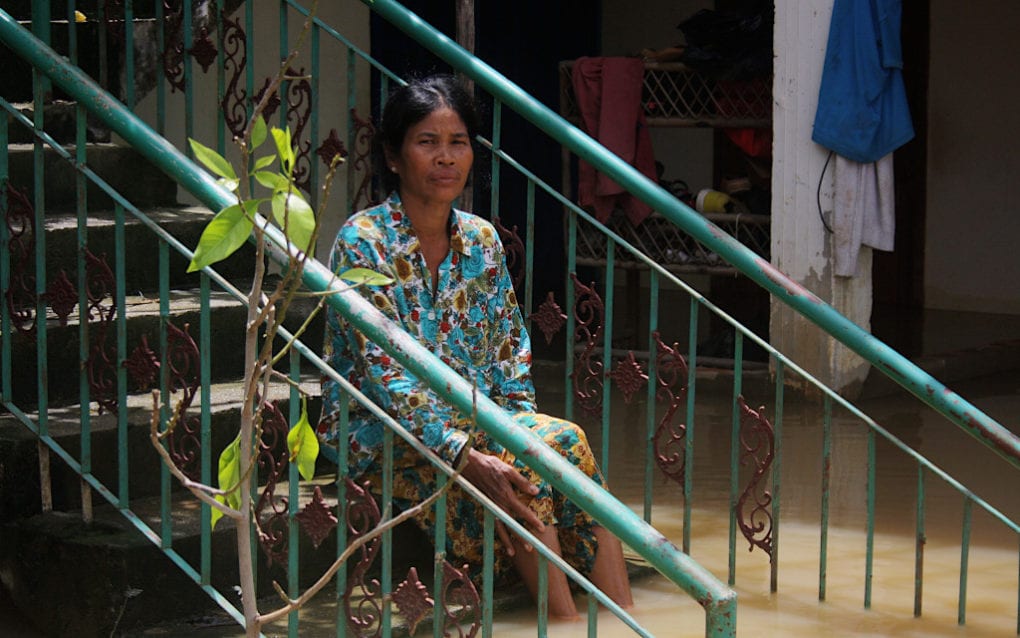 Toch Sina, 57, is staying behind at her flooded house in Spean Thma commune, in Phnom Penh’s Dangkao district, on October 12, 2020. (Michael Dickison/VOD)