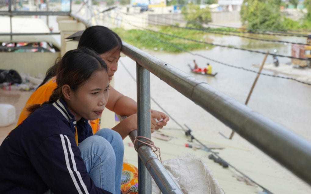Y&W factory worker Soam Sreynai, 21, looks down on flooded streets from her workers’ accommodations in Phnom Penh’s Dangkao district on October 22, 2020. (Tran Techseng/VOD)