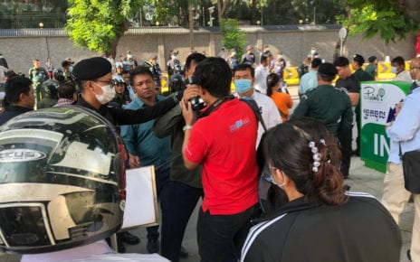 Authorities grab a camera during a small protest outside the Chinese Embassy in Phnom Penh on October 23, 2020. (Matt Surrusco/VOD)