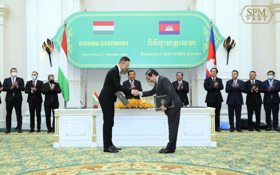 Hungarian Foreign Minister Peter Szijjarto shakes hands with Water Resources Minister Lim Kean Hor at a signing ceremony in Phnom Penh on November 3, 2020, as Prime Minister Hun Sen and other officials look on, in this photograph posted to Hun Sen's Facebook page.