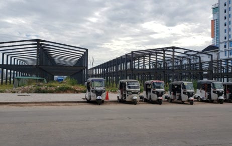A row of tuk tuks park in front of building frames in Sihanoukville on December 2, 2020. (Danielle Keeton-Olsen/VOD)