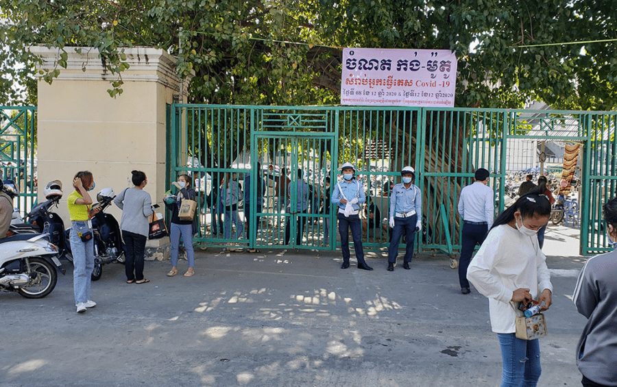 Masked police stand at the entrance of the Covid-19 testing center at Olympic Stadium in Phnom Penh on December 8, 2020. (Danielle Keeton-Olsen/VOD)