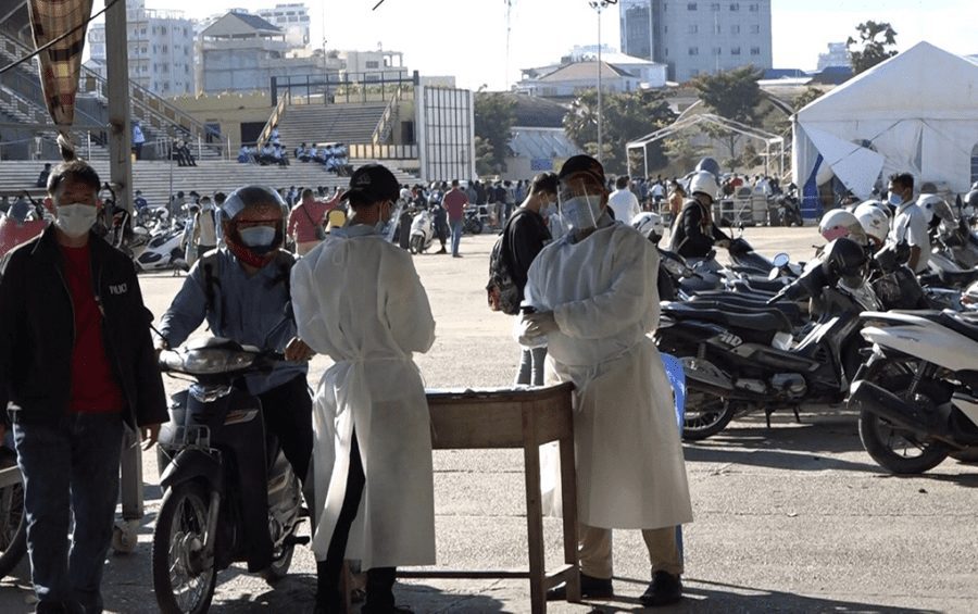 Guards spray alcohol sanitizer near motorbike parking at Olympic Stadium in Phnom Penh, which was a temporary Covid-19 testing center on December 8, 2020. (Hy Chhay/VOD)