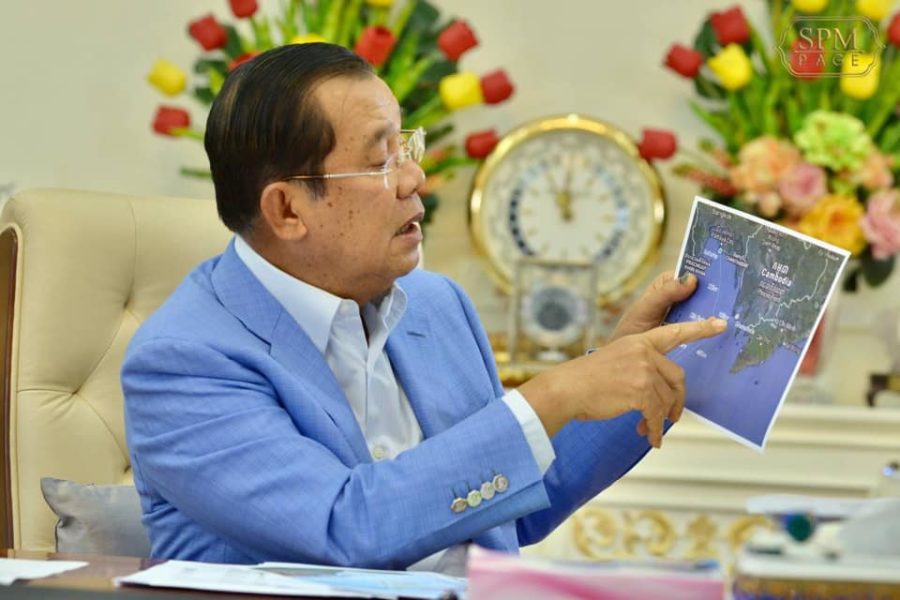 Prime Minister Hun Sen points on a map to Cambodia's Block A offshore oil concession, where KrisEnergy has extracted the nation's first drops of oil, in a photo posted to his Facebook page on December 29, 2020.