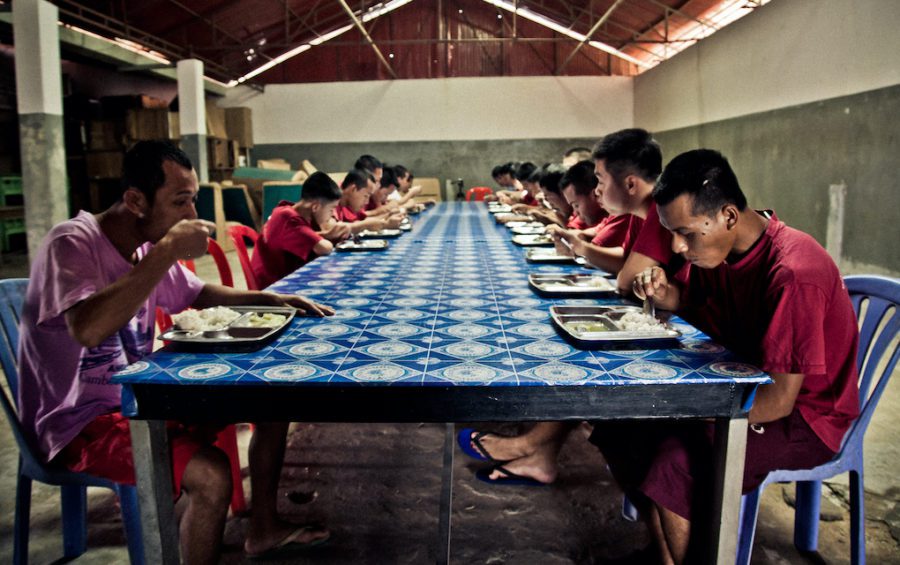 Men eat at a government-run drug rehabilitation center in Siem Reap in 2012. (Benoit Matsha-Carpentier/IFRC)