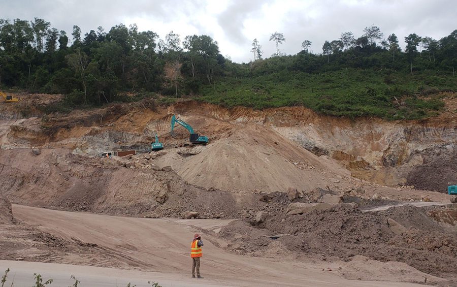 A construction worker stands in front of extensive digging of a mountain called Poy Machov in Preah Sihanouk province's Prey Nob district on December 1, 2020. (Danielle Keeton-Olsen/VOD)