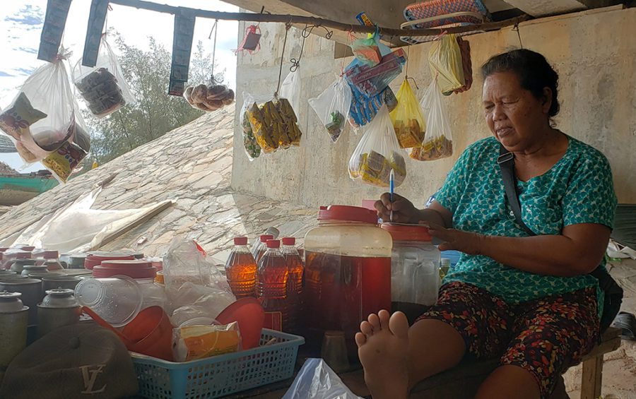 Shop owner Yang sells her wares from under a bridge after workers kicked her out from a spot along the road above, she said on December 1, 2020 in Preah Sihanouk province's Prey Nob district. (Danielle Keeton-Olsen/VOD)