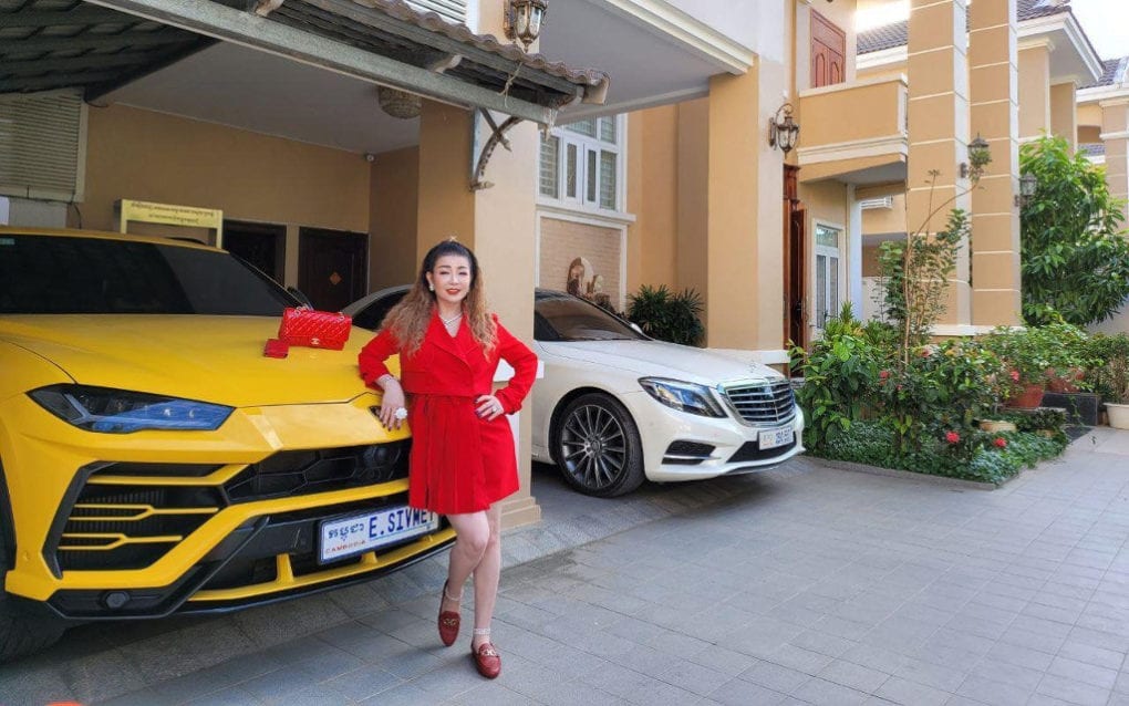 Ean Sivmey poses with a Lamborghini Urus parked at her Phnom Penh house, in a photo she posted to her business’s Facebook page on November 26, 2020.