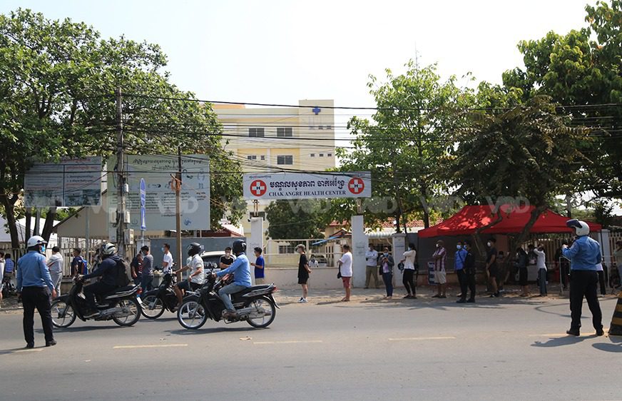 People wait in line for Covid-19 testing after a new cluster emerged at Phnom Penh's Chak Angre Health Center on February 22, 2021. (Chorn Chanren/VOD)