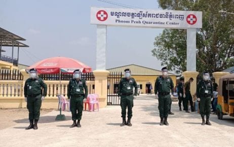 Authorities stand at attention outside a Phnom Penh quarantine center in February 2021. (Phnom Penh Police Facebook)