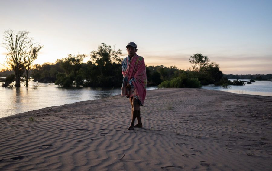 A community fishery patroller wakes up on a sandbank in the Mekong River that the team had been camping on while on the lookout for illegal fishers. (Andy Ball)