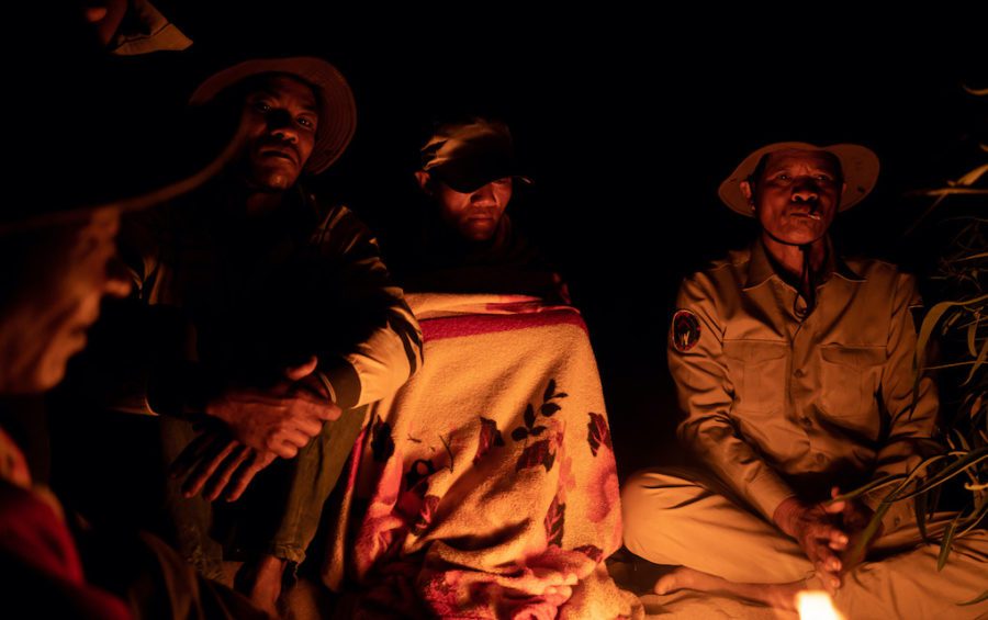 Sar Kim (right), village chief of Kampong Kbeung, and other members of the patrol team discuss whether to pursue two boats they had suspected to be illegal fishers. (Andy Ball)