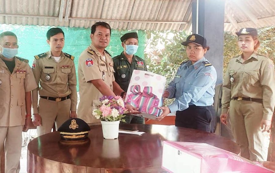 Siem Pang district police chief Chim En presents traffic police officer Sithong Sokha with a gift, in this photograph posted to the district police’s Facebook page on March 8, 2021.
