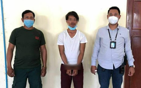 A man arrested in connection to a social media post in which he tells factory workers not to receive Chinese Covid-19 vaccines, on March 24, 2021. Wrists blurred in handout photo. (Phnom Penh Municipal Police)