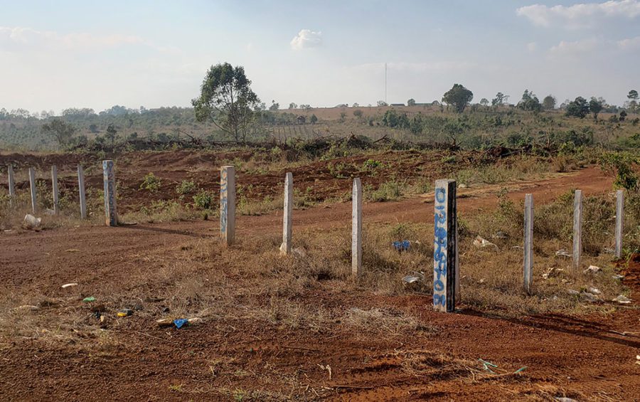 Fence posts inscribed with phone numbers partition land in Mondulkiri's O'Reang district on February 12, 2021. (Danielle Keeton-Olsen/VOD)