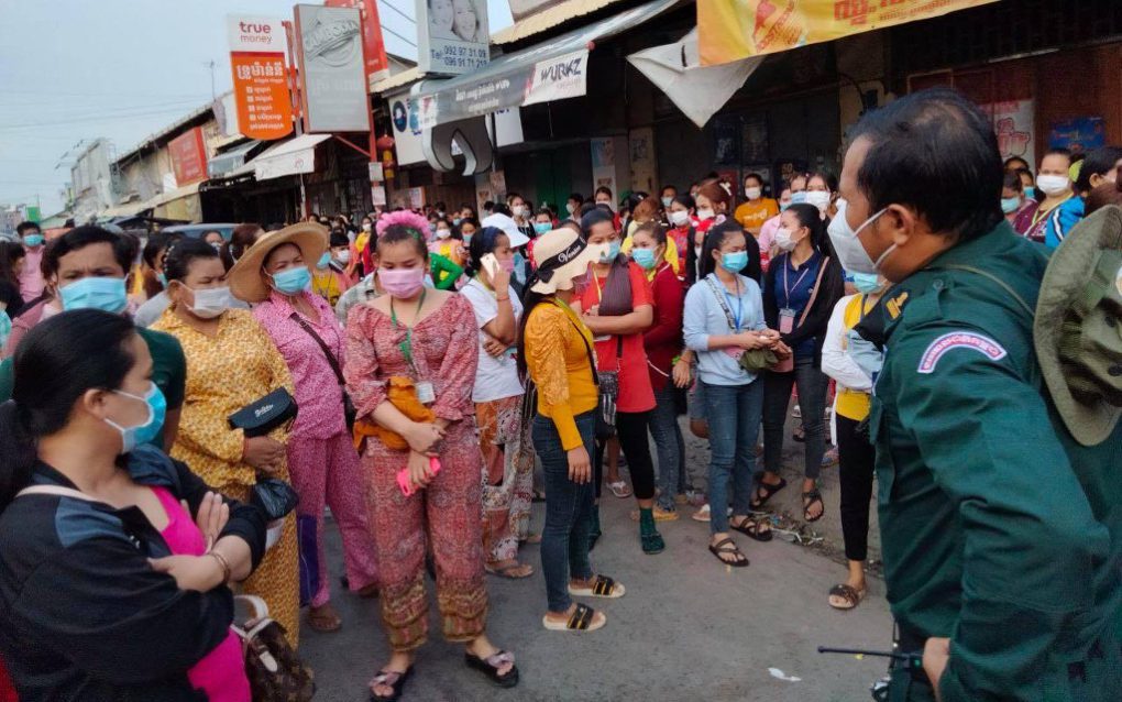 Protesters face police officers at a red-zone barrier in Meanchey district’s Stung Meanchey III commune on May 13, 2021, in a photo posted to the commune police’s Facebook page.