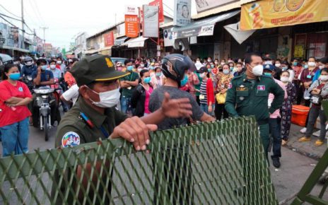 Protesters face police officers at a red-zone barrier in Meanchey district’s Stung Meanchey III commune on May 13, 2021, in a photo posted to the commune police’s Facebook page.