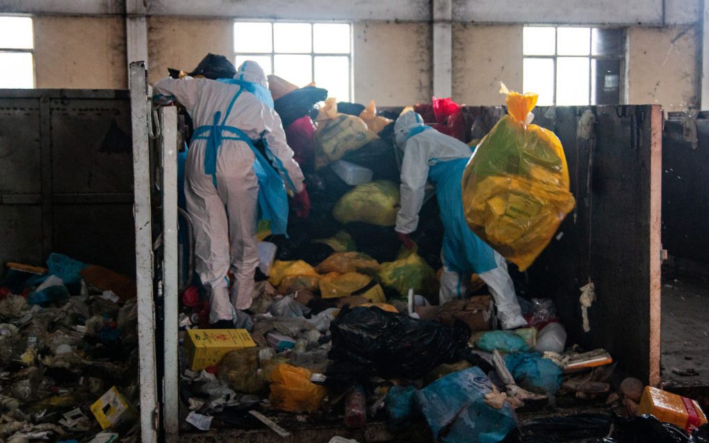 Workers sort through medical waste, in Phnom Penh’s Dangkao district on May 24, 2021. (Gerald Flynn/VOD)