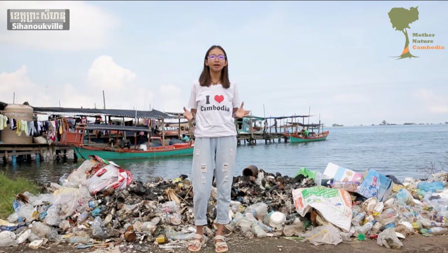 Mother Nature activist Sun Ratha stands in front of a pile of trash on the beach in Sihanoukville in a screenshot from a video posted to Facebook on January 24, 2020.