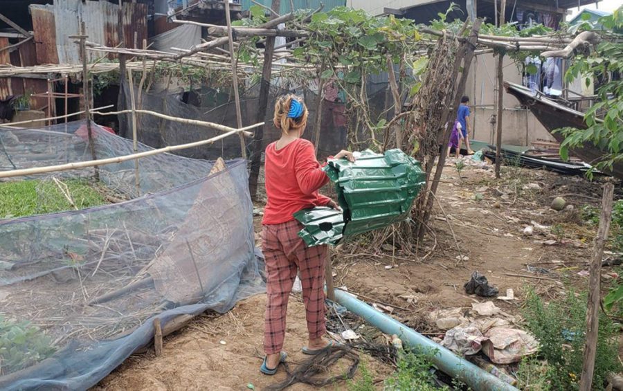 Da Lin, 37, moves pieces of her floating house after authorities warned Tonle Sap-dwelling residents they must leave in Phnom Penh's Prek Pnov village on June 10, 2021. (Danielle Keeton-Olsen/VOD)