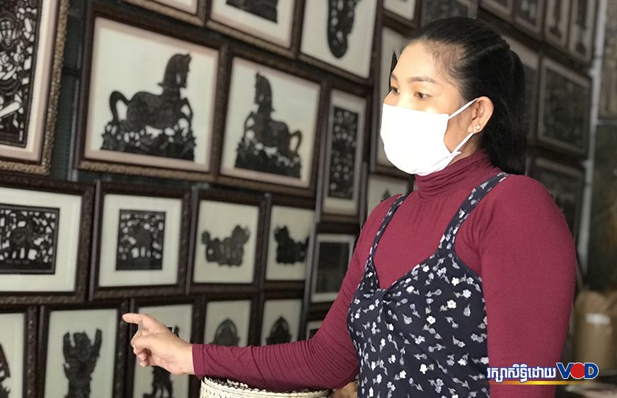 Soun Sinak points to the leather artwork she sells at her shop in Siem Reap city's Nokor Thom commune on July 5, 2021.  (Pork Kheuy/VOD)